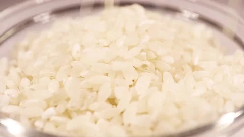 Macro pours raw rice Stock Footage 150863495