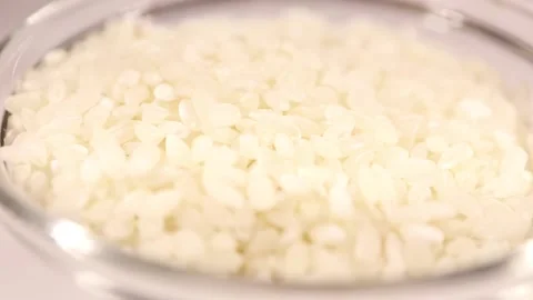 Macro pours raw rice Stock Footage 150863498