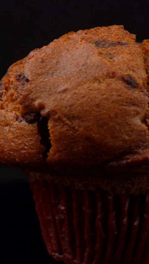 Macro Pumpkin Chocolate Chip Muffin Rotating on Dark Background Close Up Video stock 330517434