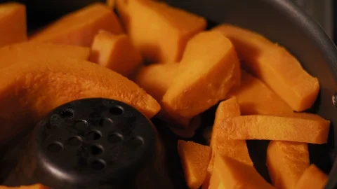 Macro, Pumpkin Cut Into large Pieces Stewed in a Pan Stock Footage 99553495