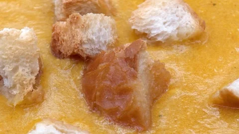 Macro pumpkin soup with croutons Video stock 327793573