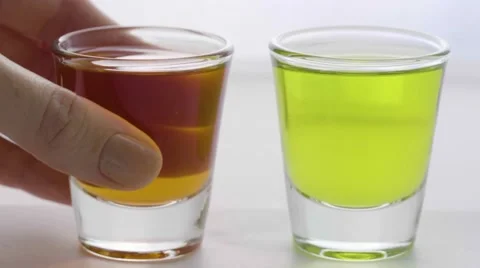 Macro putting down two shot glasses faster Stock Footage 68003020