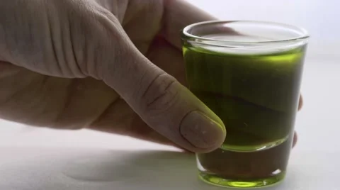 Macro putting down two shot glasses Stock Footage 68003061