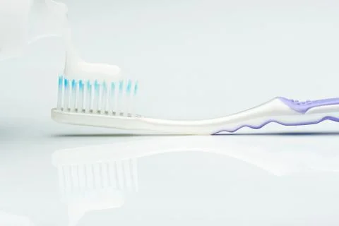 Macro of putting tooth paste Stock Photos