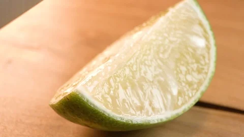 Macro quartering lime wedge Stock Footage 124444035