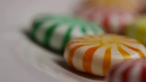 Macro rack focus along row of colorful peppermint candies Stock Footage 328085014