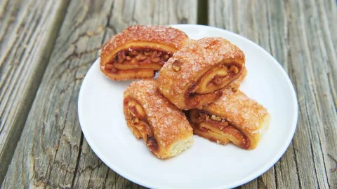 Macro rack focus of jam nut rugelach rolls pastry Jewish dessert on plate Stock Footage 165297228