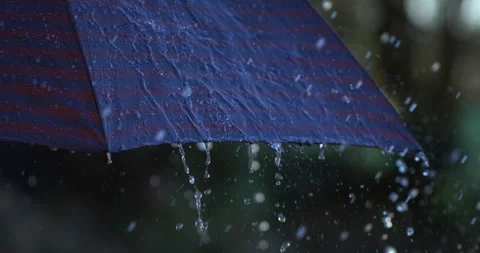 Macro of rain water drops falling with splash on umbrella while raining outside Stock Footage 269369216