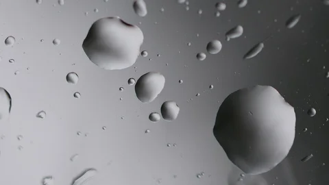 Macro raindrops falling on glass window Stock Footage 129438043