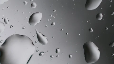 Macro raindrops falling on glass window Stock Footage 129439417
