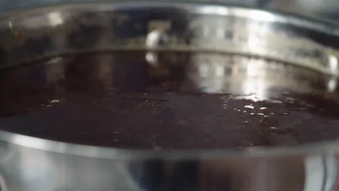 Macro, raspberry jam boils in a metal pan on the stove Stock Footage 202895940