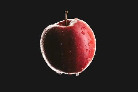 Macro of red apple isolated on black background, dark and moody food concept Stock Photos