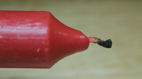 Macro of Red Candle Being Lit by Match and Catching Fire Stock Footage 1215454