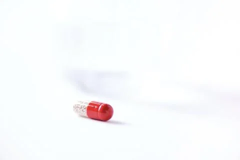 Macro of red capsules on white background. Copy space. Bunch of drugs, cold flu Stock Photos