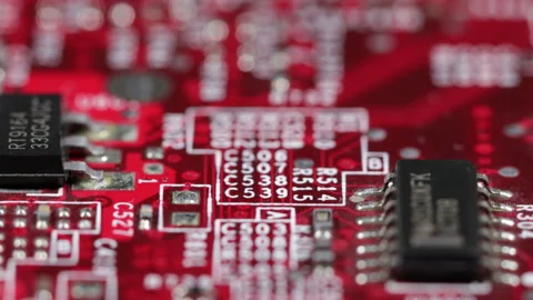 Macro of red computer circuit board with transistors and white markings Stock Footage 141334473