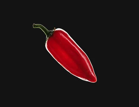 Macro of red pepper isolated on black background. Dark and moody food concept Photos