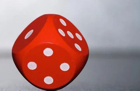 Macro of a a red rolling dice Stock Photos