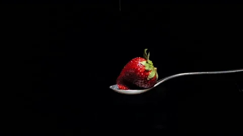 Macro of red strawberry with jet sugar in slow motion Stock Footage 131406329