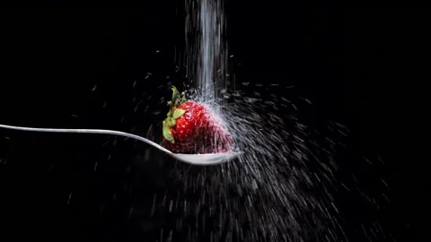 Macro of red strawberry with jet sugar in slow motion Stock Footage 131406344