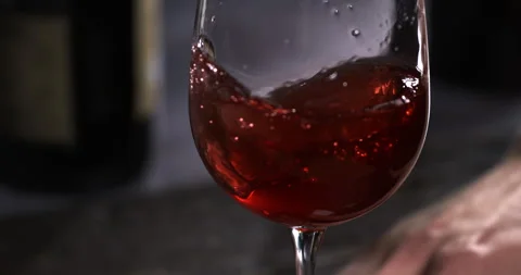 Macro of red wine poured in transparent glass in wine cellar by sommelier Stock Footage 269325265