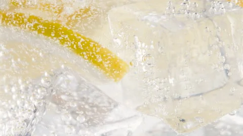Macro refreshing soda tonic fizzy sparkling water, lime in glass, ice cubes Stock Footage 155280015