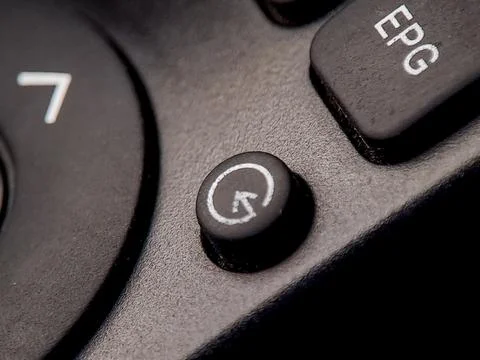 Macro of a remote control showcases button details and textured surface in .. Stock Photos