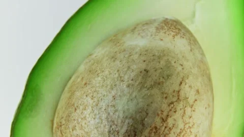 Macro Rotating Avocado Pit and Green Flesh. 스톡 동영상 334574944