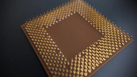 Macro rotating close-up of a CPU underside with gold pins, showing detailed.. Stock Footage 322570426
