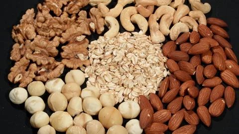 Macro Rotating Mix of Premium Nuts and Rolled Oats. Stock Footage 332829497