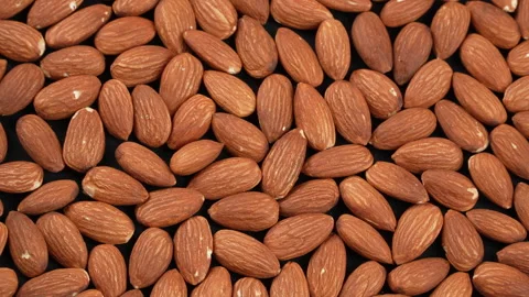 Macro Rotating Raw Almonds on Black Background 4K Stock Footage 332842989