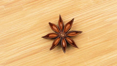 Macro Rotating Single Star Anise Pod On Wooden Board 스톡 동영상 331377343