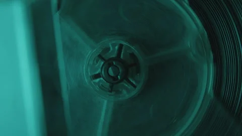 Macro of Rotating Spool of Reel-To-Reel Tape Recorder in Neon Light Stock Footage 273139246