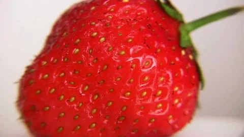 Macro rotating view of a fresh red strawberry on white background Stock-Footage 332911242