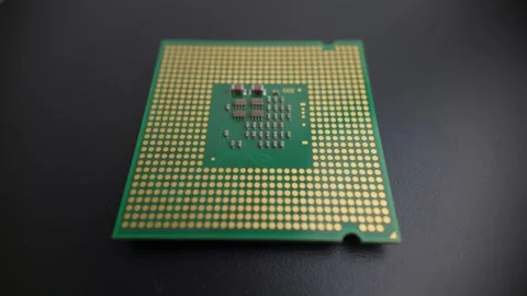 Macro rotating view of a modern CPU underside without pins, showing contact.. Stock Footage 322570422