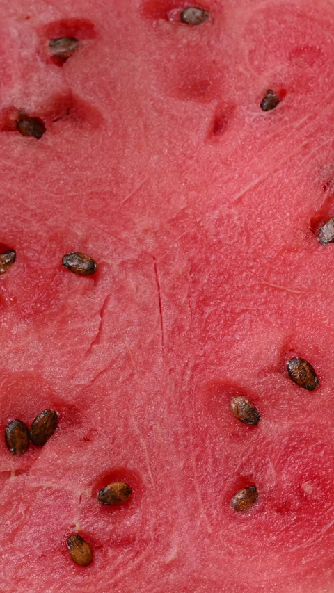 Macro rotating watermelon slice with juicy pulp and seeds. Stock Footage 315877343