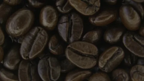 Macro Rotation of Roasted Coffee Beans Surface. Stockbeeldmateriaal 334575751