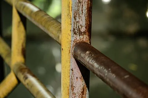 Macro of rusty iron pipe joint on railing at night Stock Photos