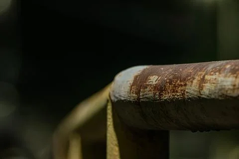 Macro of rusty iron pipe joint on walkway railing Stock Photos