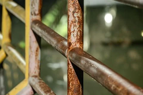 Macro of rusty iron railing in dark environment at night Фото