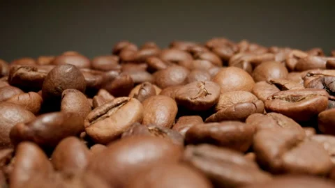 MACRO: Сamera moves over roasted coffee beans. Video stock 148196276