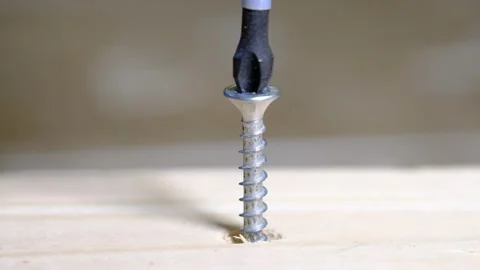 Macro of a screw being driven into wood Stock Footage 139015667