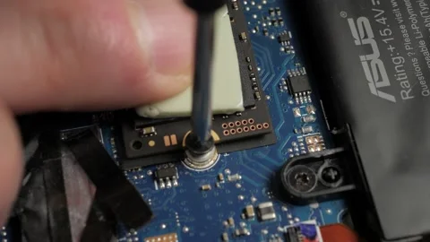 Macro Screwing in hard drive computer (2) Stock Footage 237027455