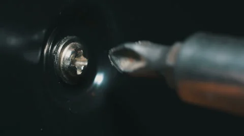 Macro of screwing off a small bolt Stock Footage 58425381