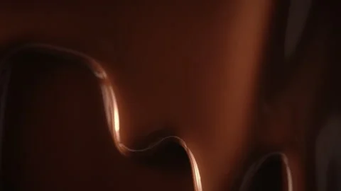 Macro seamless dripping melted liquid chocolate flows, flowing molten chocolate Stock Footage 255385990