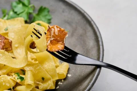 Macro selective focus fork with Italian pasta pappardelle with mushrooms Stock Photos