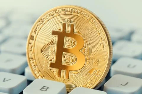 Macro shiny bitcoin on computer keyboard. virtual cryptocurrency concept Stock Photos