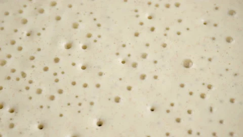 Macro shooting. Big round pancake on induction frying pan. Cooking smoke goes up Stock Footage 148565705