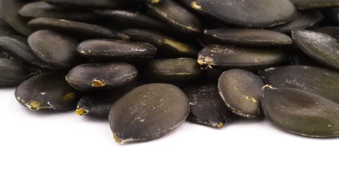 Macro shooting of bottom part of pumpkin seeds pile. Slowly rotating  Stock Footage 96339494