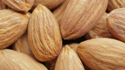 Macro shooting of a brown almonds heap. Rotating on the turntable Stock Footage 106380811