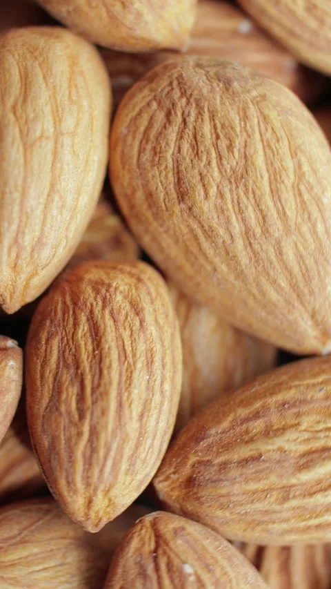 Macro shooting of a brown almonds heap. Rotating on the turntable. Stock Footage 274209277
